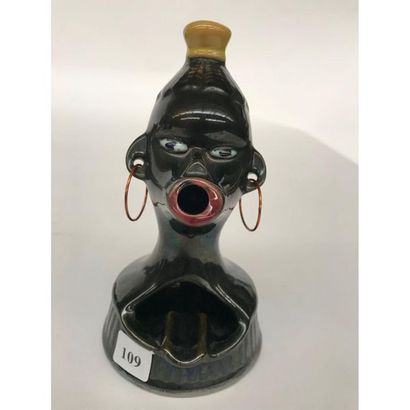 null SMOKING ASHTRAY. Anthropomorphic ashtray featuring a stylized African bust,...