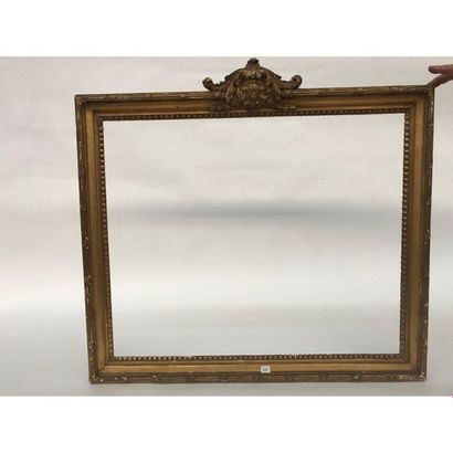 null FRAME IN THE TASTE LOUIS XVI with a mascaron and stylized motifs. Int. dim....