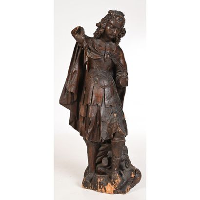 null SAINT MICHEL in carved oak with roughened back. He is shown standing, wearing...