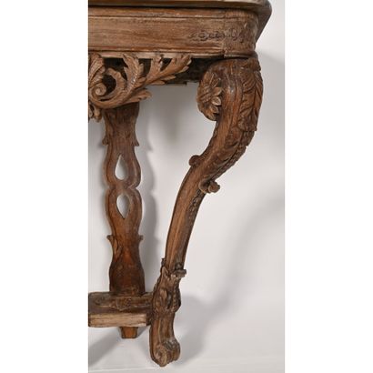 null REGENCE CONSOLE in oak with carved garlands of openwork foliage. It rests on...