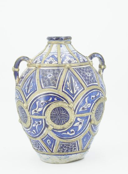 null Vase with large body and narrow neck in blue and white enamelled clay with compartmentalized...