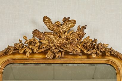 null Wood and gilded stucco mirror with a pediment decorated with an eagle.

Late...