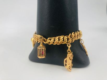 null American link bracelet in 18 K yellow gold, with charms, some in gilded metal...
