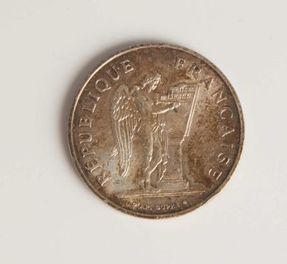 null A silver coin of 100 francs year 1989.