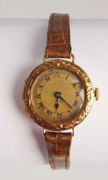 null Lady's watch in gold and gilt metal with chased foliage decoration. 

First...
