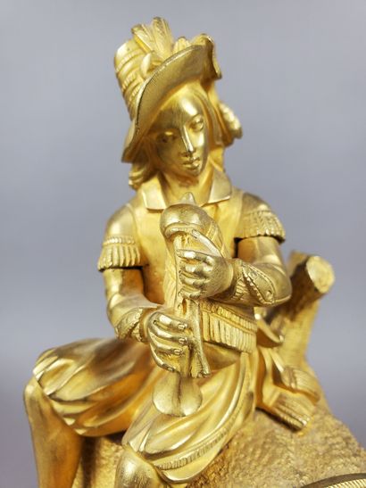 null PENDULE in matt and chased gilt bronze depicting a young man with bagpipes,...