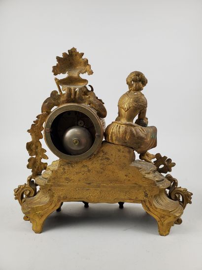 null Gilt bronze CLOCK featuring a seated young girl and richly decorated with bouquets,...