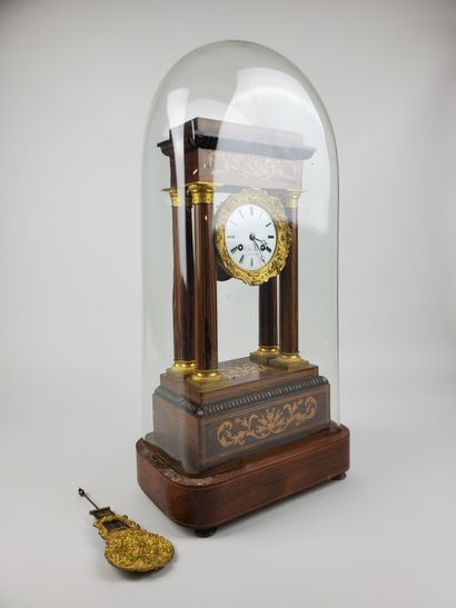 null Portico clock in the Charles X style, inlaid with rosewood and light wood, decorated...
