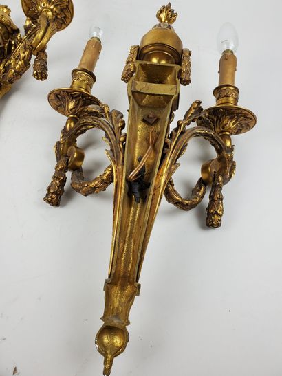 null Pair of Louis XVI style sconces in gilt and chased bronze, two arms of light,...