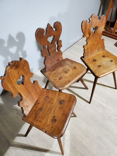 null THREE Alsatian country chairs in walnut, scalloped back decorated with an openwork...