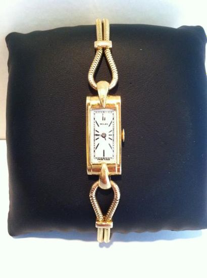 ROLEX Bracelet montre de dame en or cadran rectangulaire à fond blanc, chiffres batonnetes...