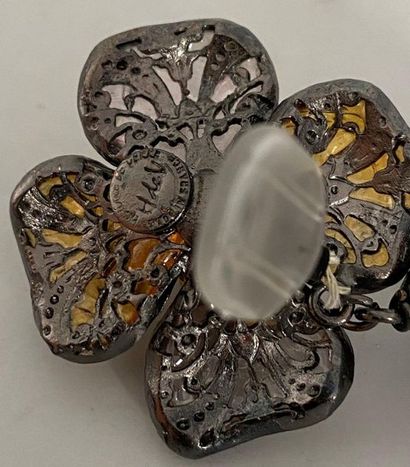 null GLASS HISTORY Pair of ear clips in blackened metal with flower motifs and amber...