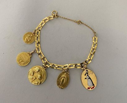 null Bracelet gourmette ornée de 5 médailles en or 750 millièmes (dont 4 religieuses...