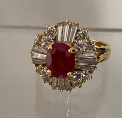 null 750 thousandths gold ring decorated with an oval ruby in a circle of round diamonds...