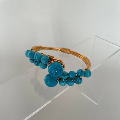 Crossed bracelet made of golden metal threads...