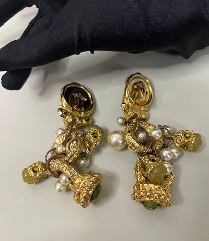 null Pair of ear clips with ram's head motif and pendants adorned with green rhinestones...