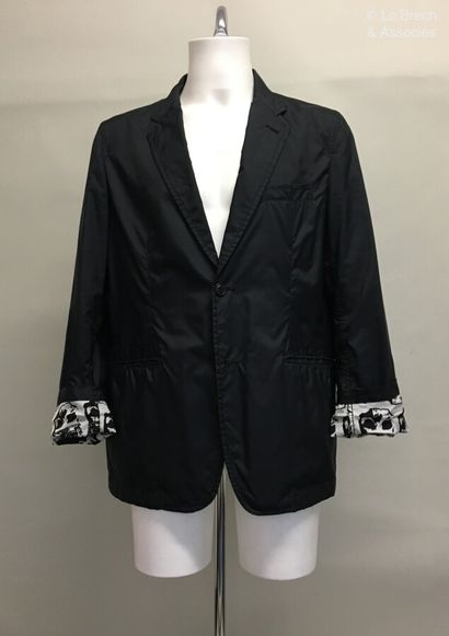 null COMME DES GARCONS Jacket in black composite material and crowned skull print...