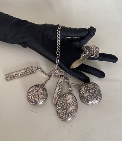 null Silver chatelaine and charms boxes and knives with floral decoration 

Circa...