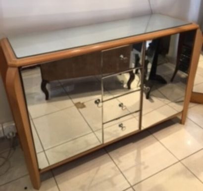 null Low sideboard in light wood and mirror with 2 leaves and 4 drawers in the center...
