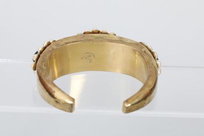 null CHANEL par Robert GOOSSENS 

Bracelet jonc en métal doré a décor de médaillons...
