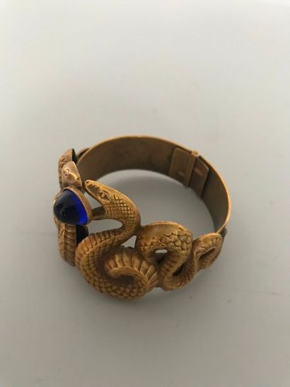 null JOSEFF 

Bracelet articulé serpents en laiton patiné centré d'une perle de verre...