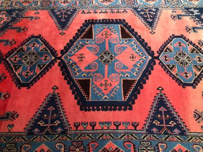 null Un tapis en laine à décor de trois médaillons sur fond rose, IRAN, 220 x 350...