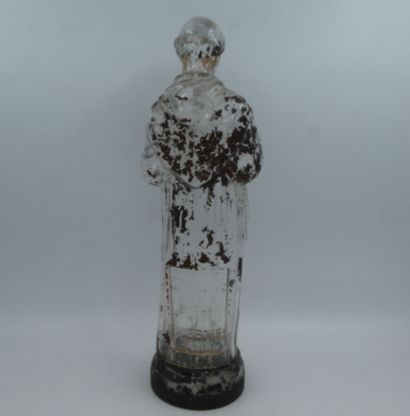 null JOHN TAVERNIER, une bouteille en verre en forme de Saint Antoine formant flacon...