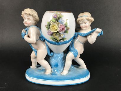 null Un sujet en porcelaine à décor de Putti soutenant un vase ovoïde florale, hauteur...