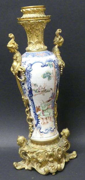 null A porcelain and polychrome enamel vase decorated with characters in front of...