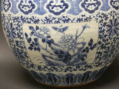 null A blue-white porcelain fishbowl decorated with plants and butterflies in cartouches,...