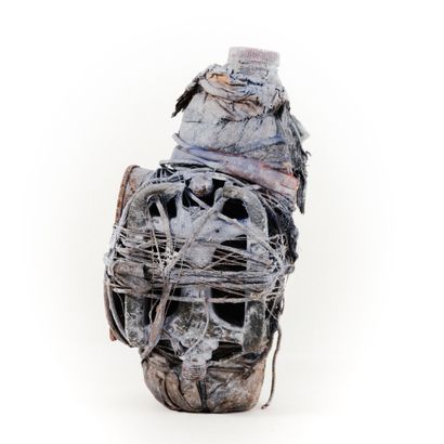 null FON- BENIN 

Bo bottle filled with a medicinal solution swaddled in a white...