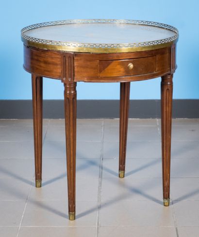 null Mahogany and mahogany veneer bouillote table, marble top, brass gallery.

Louis...