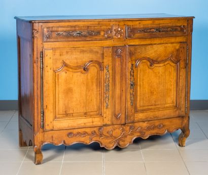 null Moulded walnut sideboard opening with two leaves and two drawers. Carved decoration...