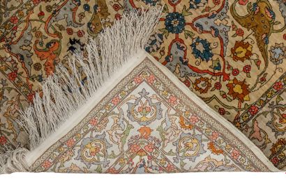 null Silk carpet finely decorated with stylized floral motifs on a beige background.

116...