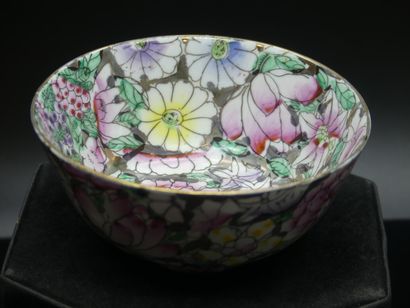 Polychrome porcelain cup with floral decoration....