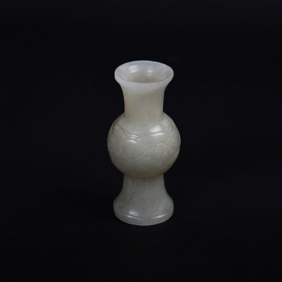 null Small celadon white jade Gu vase, decorated with flowers and foaming waves on...