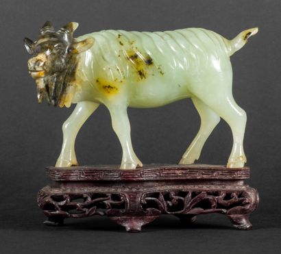 null Green and brown serpentine subject representing a goat.

China, around 1930

H...