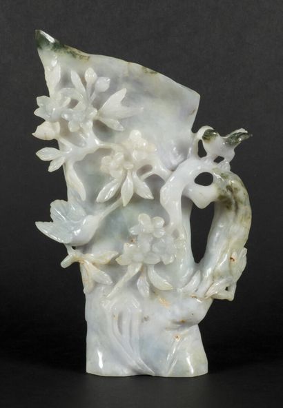 null Vase in the imitation of a prunus trunk in bloom n serpentine, Honan jade.

China,...