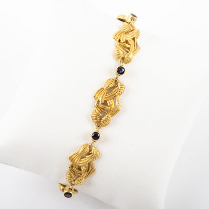 null Stylized gold bracelet, fancy mesh punctuated with blue stones in closed setting

...