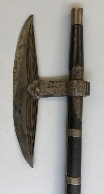 null Votive axe of undetermined origin. Symmetrical crescent-shaped iron set on an...