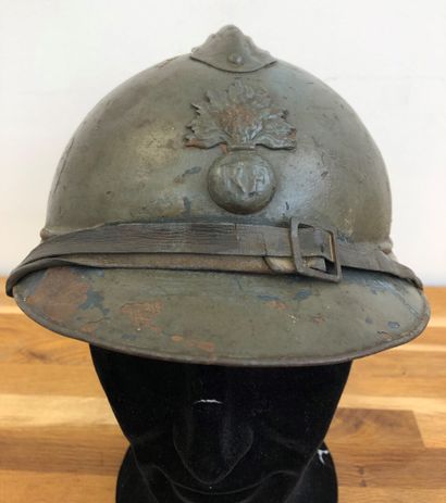 null Adrian helmet model 1915 of infantry repainted green on blue horizon base, with...