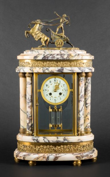 null Portico clock in marble and brass and glass cage, topped by a chariot.

Louis...