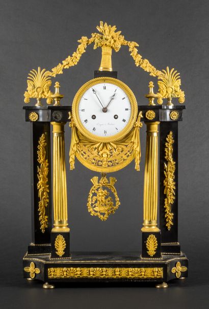 null Gilt bronze and black marble clock with columns decoration.

Dial marked "Compans...