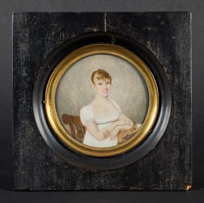 null Miniature in round ivory.

Young woman in a white dress sitting on a chair holding...