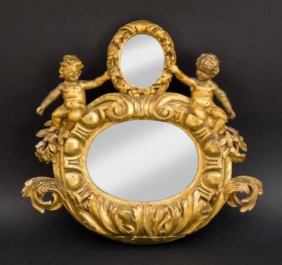 Carved and gilded wood mirror decorated with...