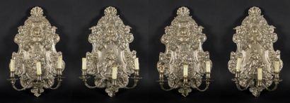 Suite of four three-light sconces in silvered...