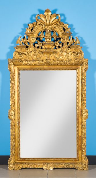 null Mirror with pediment in carved and gilded molded wood, openwork decoration of...