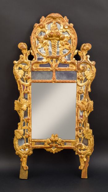 null Glass with parecloses. Wooden frame carved with pampers. The openwork pediment...