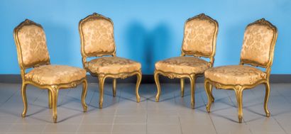 null Suite of four chairs in carved and gilded wood decorated with palmettes. Backrest,...