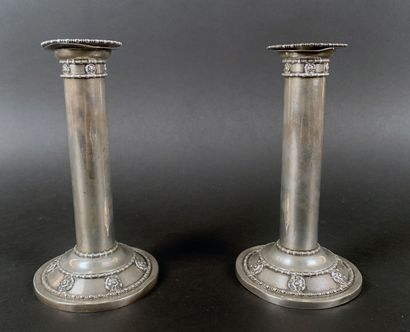 Pair of silver candlesticks decorated with...